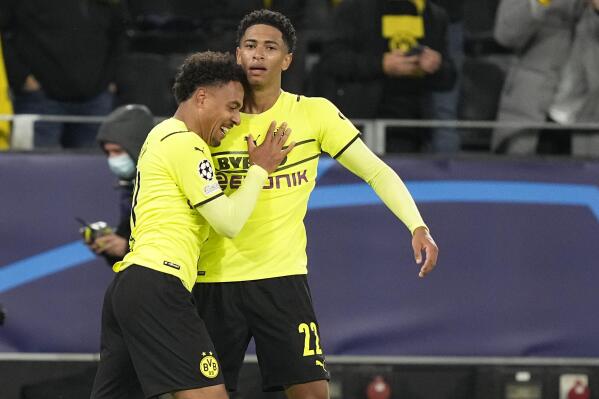 Dortmund's Donyell Malen, left, celebrates with Dortmund's Jude Bellingham after scoring his side's opening goal during the Champions League Group C soccer match between Borussia Dortmund and Sporting CP Lisbon, in Dortmund, Germany, Tuesday, Sept. 28, 2021. (AP Photo/Martin Meissner)