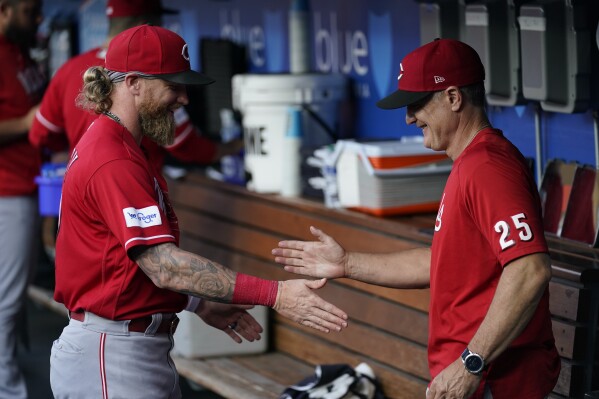 Cincinnati Reds manager David Bell (25) greets right fielder Jake Fraley in the dugout before a baseball game against the Los Angeles Dodgers in Los Angeles, Friday, July 28, 2023. (AP Photo/Ashley Landis)