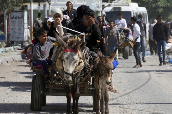 Palestinians flee from northern Gaza to the south after the Israeli army issued an unprecedented evacuation warning to a population of over 1 million people in northern Gaza and Gaza City to seek refuge in the south ahead of a possible Israeli ground invasion, Friday, Oct. 13, 2023. (AP Photo/Hatem Moussa)
