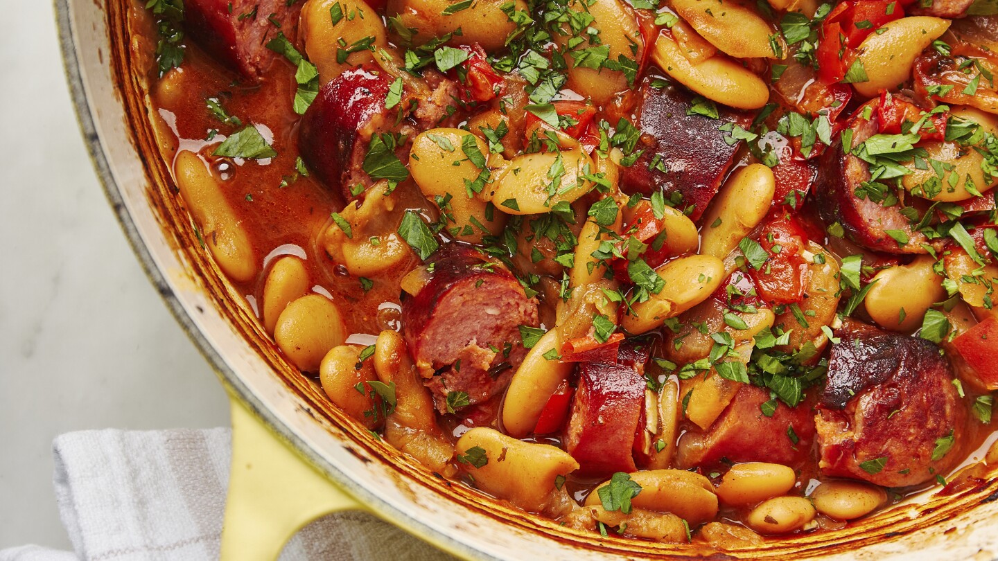 A rustic dish of beans in the oven and smoked sausages has deep and aromatic flavors