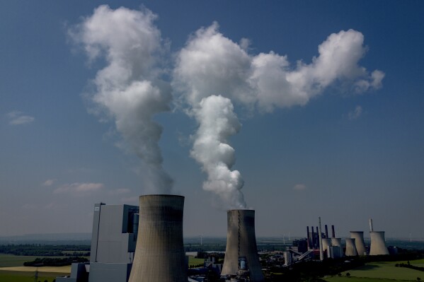 FILE - Steam rises from the coal-fired power plant in Neurath, Germany, on June 8, 2023. Carbon dioxide emissions in Germany, Europe's biggest economy, dropped to their lowest level in seven decades last year as the use of coal declined unexpectedly sharply and economic pressures weighed down industrial production, according to a study released Thursday Jan. 4, 2024. (AP Photo/Michael Probst, File)