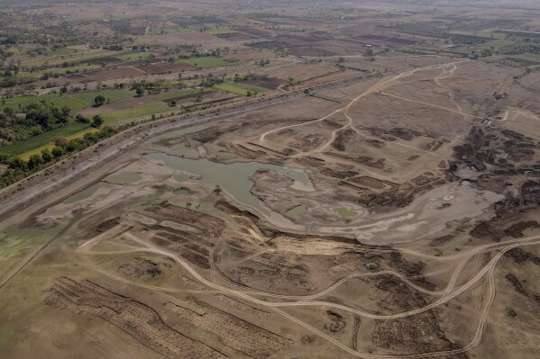 The dried up Tagadgaon Dam is visible in Beed district, India, Sunday, May 5, 2024. As the country continues to vote in its marathon six-week election, farmers are looking for longer-term solutions to the water problem. (AP Photo/Rafiq Maqbool)