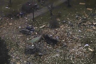 This image from video shows the remains of a house scattered after an explosion in Northfield Township, Mich., on Saturday Dec. 30, 2023. Several were killed and injured. (WXYZ via AP)