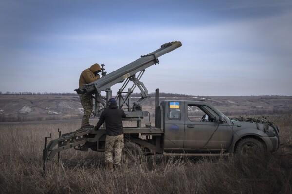 FILE - Ukrainian soldiers from The 56th Separate Motorized Infantry Mariupol Brigade prepare to fire a multiple launch rocket system based on a pickup truck towards Russian positions at the front line, near Bakhmut, Donetsk region, Ukraine, March 5, 2024. Senior U.S. defense officials said Tuesday, March 12, that the Pentagon will rush about $300 million in weapons to Ukraine after finding some cost savings in its contracts, even though the military remains deeply overdrawn. (AP Photo/Efrem Lukatsky, File)