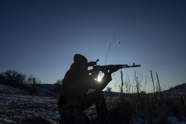 "Sirko", a Ukrainian serviceman of Karpatska Sich battalion tests his AK-74 rifle near the recently retaken town of Lyman, Ukraine, Sunday, Jan. 8, 2023. (AP Photo/Evgeniy Maloletka)