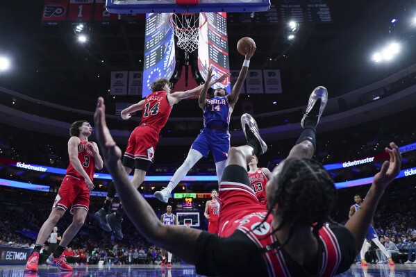 Philadelphia 76ers' Ricky Council IV, right, goes up for a shot against Chicago Bulls' Matas Buzelis during the second half of an NBA basketball game Monday, Feb. 24, 2025, in Philadelphia. (AP Photo/Matt Slocum)