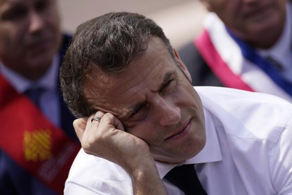 French President Emmanuel Macron listens to school children, parents and teachers as he visits a middle school, Thursday, April 20, 2023 in Ganges, southern France. Emmanuel Macron's trip to Ganges comes amid a concerted new effort by him and his government to put the furor caused by the pension change behind him. (AP Photo/Daniel Cole, Pool)