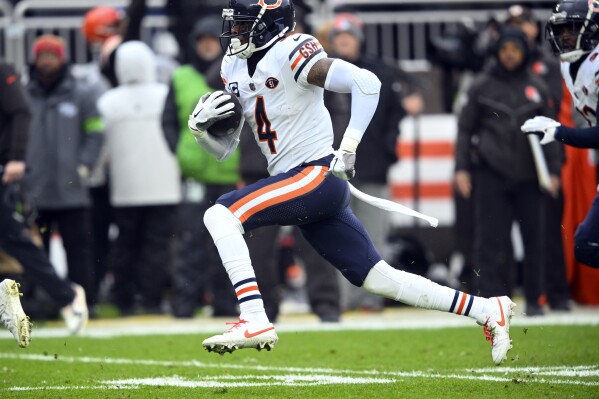 FILE - Chicago Bears safety Eddie Jackson (4) returns an interception in the first half of an NFL football game against the Cleveland Browns in Cleveland, Dec. 17, 2023. The Bears have waived former All-Pro safety Jackson and offensive lineman Cody Whitehair. (AP Photo/David Richard, File)