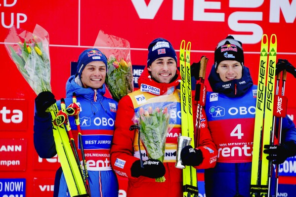 Winner Jarl Magnus Riiber of Norway, center, second placed Johannes Lamparter from Austria, left, and third placed Kristjan Ilves from Estonia celebrate after the men's 10km combined, during the Cross-Country Ski World Cup, in Holmenkollen, Norway, Sunday, March 10, 2024. (Terje Pedersen/NTB Scanpix via AP)