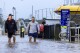Conor Lang and Anthony Heeney walk through flooded areas in Port Macquarie, north of Sydney, Australia, Wednesday, May 21, 2025. (Lindsay Moller/AAP Image via AP)
