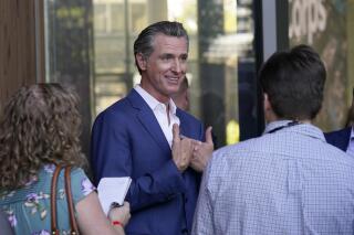 FILE - California Gov. Gavin Newsom speaks with reporters said on Friday, Oct. 7, 2022, in Sacramento. California lawmakers are having their first public hearing on a proposal to penalize some oil company profits. Newsom proposed the law in response to record high gas prices over the summer. (AP Photo/Rich Pedroncelli)