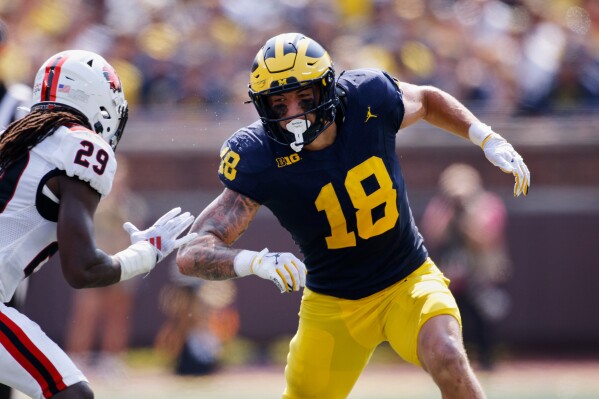 Michigan tight end Colston Loveland (18) maneuvers against Arkansas State safety Justin Parks during an NCAA football game on Saturday, Sept. 14, 2024, in Ann Arbor, Mich. (AP Photo/Al Goldis, File)