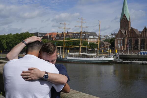 U.S. Army veteran Spencer Sullivan, right, and Abdulhaq Sodais, who served as a translator in Afghanistan, both hug and cry during an interview in Bremen, Germany, Saturday, Aug. 14, 2021. Sullivan is trying to help Sodais get asylum after he had to flee to Germany. (AP Photo/Peter Dejong)