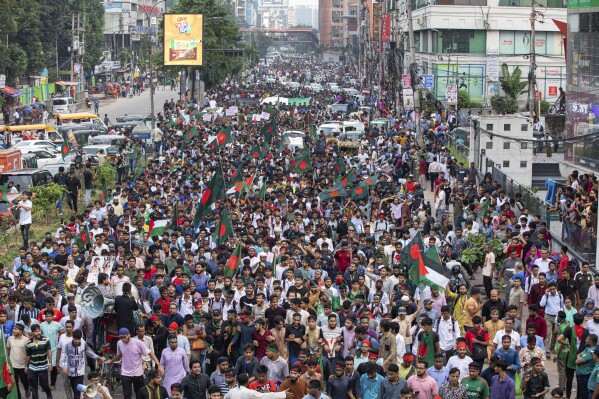 Students and other activists carry Bangladesh's national flag during a protest march organized by Students Against Discrimination to mark one month since former Prime Minister Sheikh Hasina stepped down after a mass uprising, in Dhaka, Bangladesh, Thursday, Sept. 5, 2024. (AP Photo/Rajib Dhar)