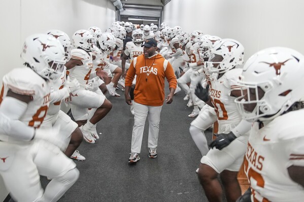 Texas director of football performance Torre Becton warms up the team in the hallway before taking the field to compete against TCU in an NCAA college football game, Saturday, Nov. 11, 2023, in Fort Worth, Texas. (Ricardo B. Brazziell/Austin American-Statesman via AP)