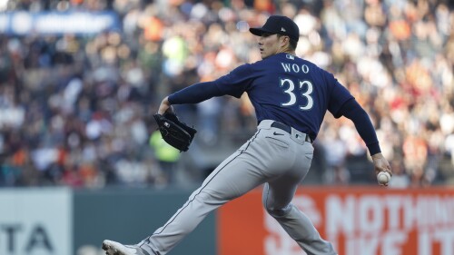 Seattle Mariners starting pitcher Bryan Woo throws in the first inning of a baseball game against the San Francisco Giants in San Francisco, Monday, July 3, 2023. (AP Photo/Josie Lepe)