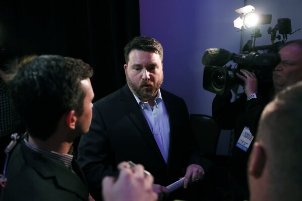 Iowa Democratic Party chairman Troy Price speaks to reporters about the delay in Iowa caucus results, Tuesday, Feb. 4, 2020, in Des Moines, Iowa. (AP Photo/Charlie Neibergall)