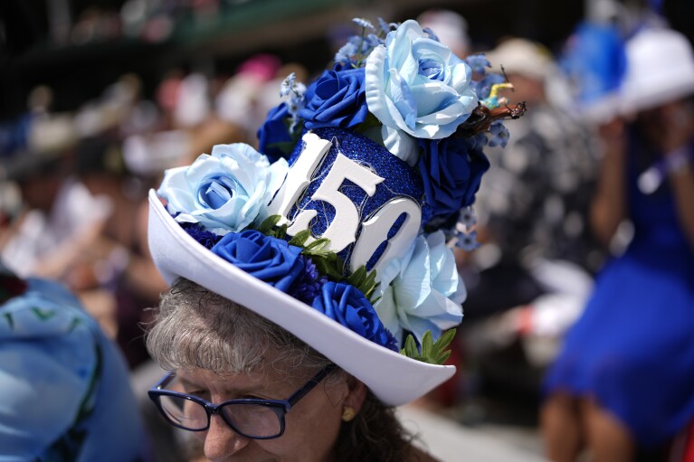 A race fan sits in the stands at Churchill Downs before the 150th running of the Kentucky Derby horse race Saturday, May 4, 2024, in Louisville, Ky. (AP Photo/Brynn Anderson)