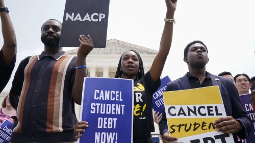 Jordan Braithwaite, 21, center, an undergrad at Grambling State University facing over $10,000 in student loans, demonstrates outside the Supreme Court, Friday, June 30, 2023, in Washington. A sharply divided Supreme Court has ruled that the Biden administration overstepped its authority in trying to cancel or reduce student loan debts for millions of Americans. Conservative justices were in the majority in Friday's 6-3 decision that effectively killed the $400 billion plan that President Joe Biden announced last year. (AP Photo/Jacquelyn Martin)