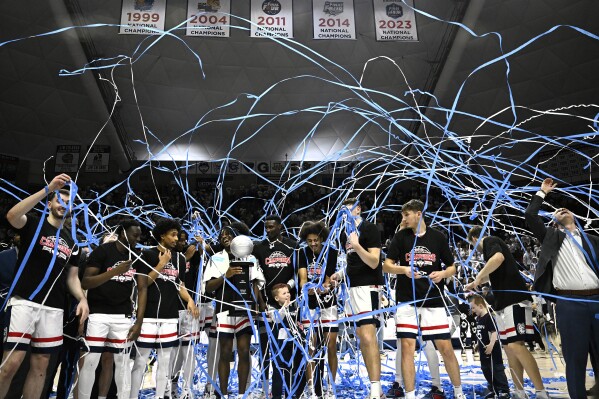 UConn celebrates winning their first outright Big East regular-season title in 25 years after an NCAA college basketball game against Seton Hall, Sunday, March 3, 2024, in Storrs, Conn. (AP Photo/Jessica Hill)