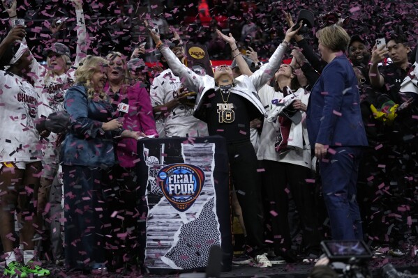 South Carolina head coach Dawn Staley celebrates after the Final Four college basketball championship game against Iowa in the women's NCAA Tournament, Sunday, April 7, 2024, in Cleveland. South Carolina won 87-75. (AP Photo/Carolyn Kaster)