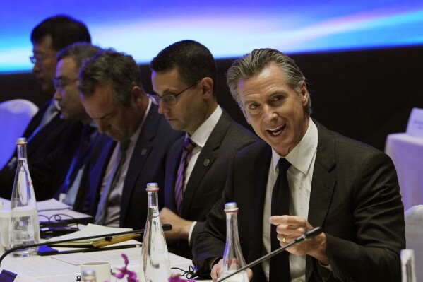 California Gov. Gavin Newsom, right, speaks during the Great Wall Climate Dialogue held at the Yanqi hotel on the outskirts of Beijing, Thursday, Oct. 26, 2023. Newsom is on a weeklong tour of China to push for climate cooperation. (AP Photo/Ng Han Guan)
