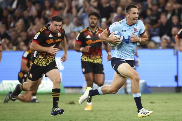 Jake Gordon from the Waratahs runs to score a try during the Super Rugby rugby match between the Waratahs and the Chiefs in Sydney, Australia, Friday, March 24, 2023. (David Gray/AAP Image via AP)