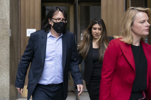 FILE - Edward Kosinski, left, departs criminal court after being indicted for conspiracy involving handwritten notes for the Eagles album "Hotel California," July 12, 2022, in New York. On Wednesday, Feb. 21, 2024, an unusual criminal trial is set to open over the handwritten lyrics. (AP Photo/John Minchillo, File)