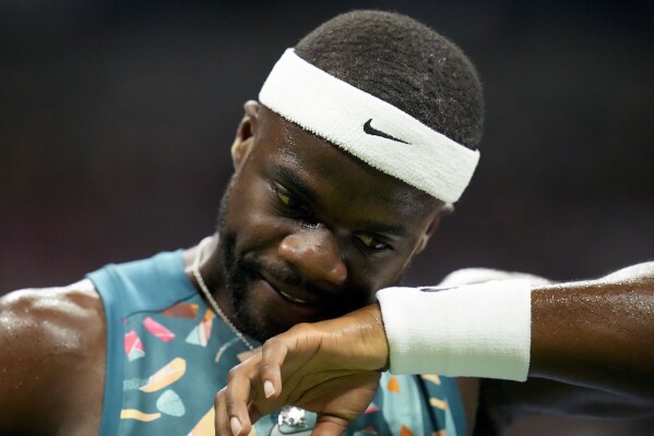 Frances Tiafoe, of the United States, wipes sweat from his face during a match against Ben Shelton, of the United States, during the quarterfinals of the U.S. Open tennis championships, Tuesday, Sept. 5, 2023, in New York. (AP Photo/Charles Krupa)
