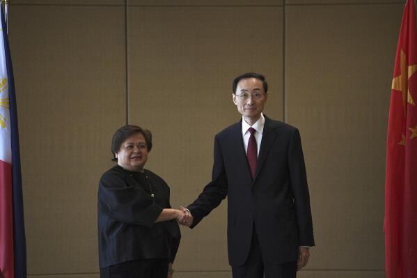 Theresa Lazaro, left, Philippines' Undersecretary for Bilateral Relations and Asian Affairs of the Department of Foreign Affairs, shake hands with Sun Weidong, China's Vice Foreign Minister, prior to the start of the Philippines-China Foreign Ministry consultation meeting at a hotel in Manila Thursday, March 23, 2023.(Ted Aljibe/Pool via AP)