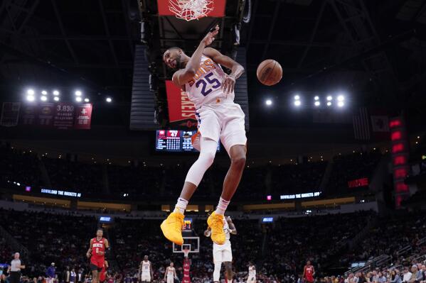 Phoenix Suns' Mikal Bridges (25) dunks the ball against the Houston Rockets during the first half of an NBA basketball game Wednesday, March 16, 2022, in Houston. (AP Photo/David J. Phillip)