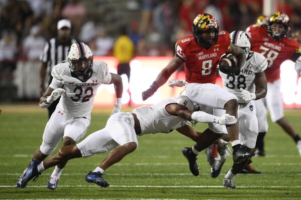 Maryland running back Tayon Fleet-Davis (8) runs with the ball against Howard defensive back Carson Hinton (4) during the first half of an NCAA college football game, Saturday, Sept. 11, 2021, in College Park, Md. (AP Photo/Nick Wass)