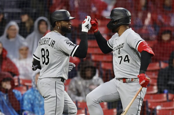Chicago White Sox's Luis Robert Jr. (88) celebrates after his solo home run with Eloy Jimenez (74) during the ninth inning of a baseball game against the Boston Red Sox, Saturday, Sept. 23, 2023, in Boston. (AP Photo/Michael Dwyer)