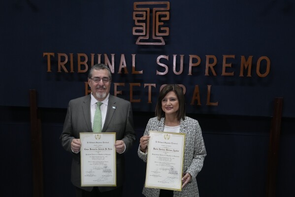 President-elect Bernardo Arévalo and Vice President-elect Karin Herrera pose with their presidential election winners' certificate at the Supreme Electoral Tribunal in Guatemala City, Tuesday, Sept. 5, 2023. (AP Photo/Moises Castillo)