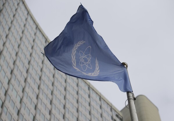 FILE - The flag of the International Atomic Energy Agency flies in front of its headquarters during an IAEA Board of Governors meeting in Vienna, Austria, Monday, Feb. 6, 2023. Iran has slowed its enrichment of uranium at nearly weapons-grade levels, a report by the United Nations' nuclear watchdog seen by The Associated Press said Monday, Sept. 4, 2023. (AP Photo/Heinz-Peter Bader, File)