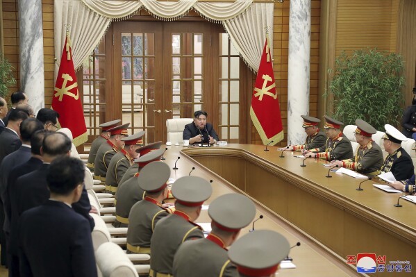 In this photo provided by the North Korean government, North Korean leader Kim Jong Un, top center, meets with commanding army officers in Pyongyang, North Korea, Sunday, Dec. 31, 2023. Independent journalists were not given access to cover the event depicted in this image distributed by the North Korean government. The content of this image is as provided and cannot be independently verified. Korean language watermark on image as provided by source reads: "KCNA" which is the abbreviation for Korean Central News Agency. (Korean Central News Agency/Korea News Service via AP)