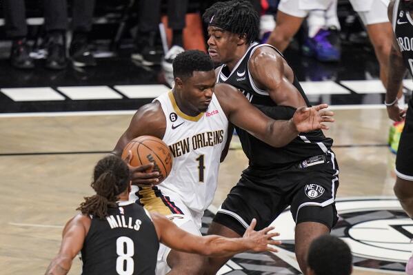New Orleans Pelicans' Zion Williamson (1) drives past Brooklyn Nets' Day'Ron Sharpe and Patty Mills (8) during the second half of an NBA basketball game Wednesday, Oct. 19, 2022, in New York. (AP Photo/Frank Franklin II)