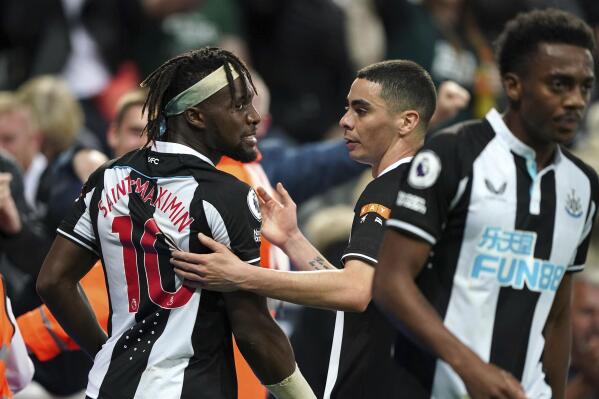 Newcastle's Allan Saint-Maximin, left, celebrates with teammates after scoring his side's first goal of the game during their English Premier League soccer match at St James' Park, Newcastle, England, Friday, Sept. 17, 2021. (Owen Humphreys/PA via AP)
