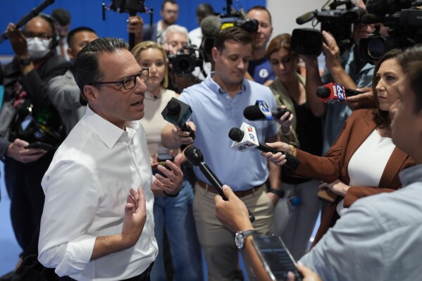 Pennsylvania Gov. Josh Shapiro speaks with members of the media during his visit to Philadelphia Youth Basketball's new Alan Horwitz "Sixth Man" Center in Philadelphia, Tuesday, July 30, 2024. (AP Photo/Matt Rourke)