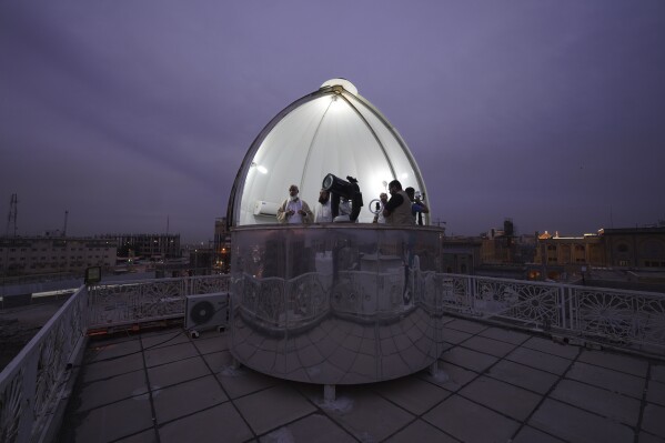 FILE - Shiites observe the crescent moon to determine the start of the tenth Islamic month of Shawwal, which marks the end of a month-long fasting of Ramadan and the beginning of the Eid al-Fitr festival in Najaf, Iraq, Thursday, April 20, 2023. (AP Photo/Anmar Khalil, File)