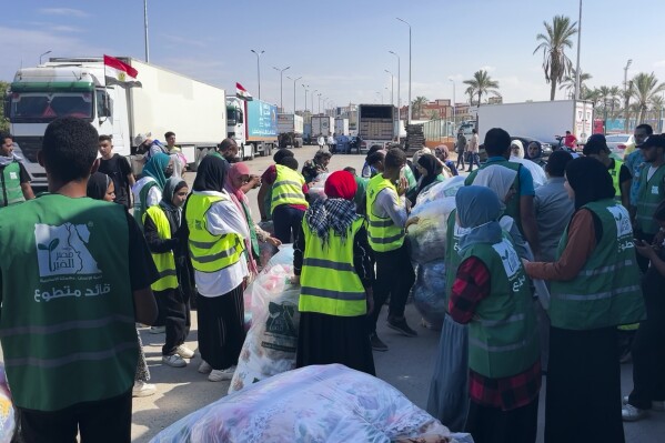 Humanitarian aid convoy for the Gaza Strip is parked in Arish, Egypt, Monday, Oct. 16, 2023. Hundreds of Palestinians in the Gaza Strip have fled their homes ahead of an expected Israeli ground invasion aimed at destroying Hamas after its fighters rampaged through southern Israel. (AP Photo/Omar Aziz)