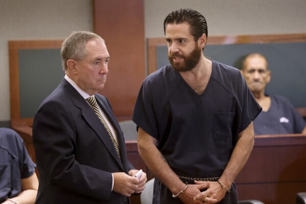 Matthew Mannix, who is accused of holding a woman hostage in a Caesars Palace hotel room, appears in court with his attorney David Roger at the Regional Justice Center in Las Vegas, Monday, Aug. 14, 2023. Mannix, now 36, pleaded guilty Thursday, Aug. 17, 2023, to felony property destruction and misdemeanor negligence charges and agreed to pay nearly $55,300 in restitution, attorney David Roger said. Prosecutors agreed to drop more serious felony kidnapping and coercion charges, according to court documents. (K.M. Cannon/Las Vegas Review-Journal via AP)