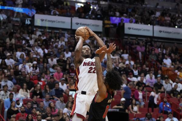 Miami Heat forward Jimmy Butler (22) shoots over Chicago Bulls guard Coby White (0) during the first half of an NBA basketball play-in tournament game, Friday, April 14, 2023, in Miami. (AP Photo/Rebecca Blackwell)