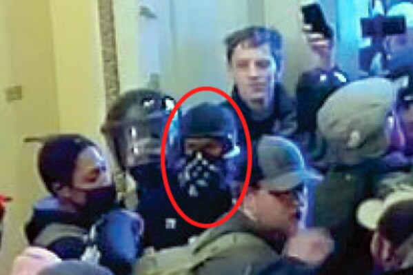 This image from U.S. Capitol Police video, released and annotated by the Justice Department in the statement of facts supporting an arrest warrant for Nathan Donald Pelham, shows Pelham, circled in red, appearing on police body-worn camera footage at the U.S. Capitol on Jan. 6, 2021, in Washington. Pelham, a Texas man who shot toward sheriff's deputies making a welfare call to his house on the day he'd agreed to surrender on charges for taking part in the in the U.S. Capitol riot, was sentenced to two years in prison Wednesday, Nov. 29, 2023, after pleading guilty to illegally possessing a firearm. (Justice Department via AP)