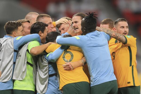 Australia's players clebrate after a qualifying match between United Arab Emirates and Australia in Al Rayyan, Qatar, Tuesday, June 7 2022. (AP Photo/Hussein Sayed)
