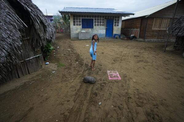 A girl pulls a rope with a turtle shell in Armila, Panama, Saturday, May 20, 2023. Sea turtles in Panama now have the legal right to live in an environment free of pollution and other detrimental impacts caused by humans, a change that represents a different way of thinking about how to protect wildlife. (AP Photo/Arnulfo Franco)