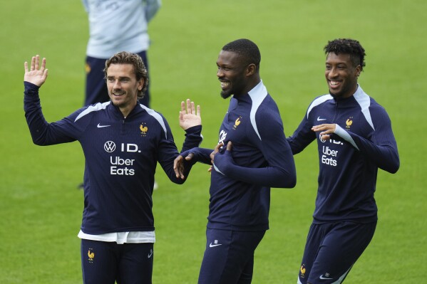 France's Antoine Griezmann, left, France's Marcus Thuram, center, France's Kingsley Coman gesture during a training session in Paderborn, Germany, Saturday, June 15, 2024. France will play against Austria during their Group D soccer match at the Euro 2024 soccer tournament on June 17. (AP Photo/Hassan Ammar)