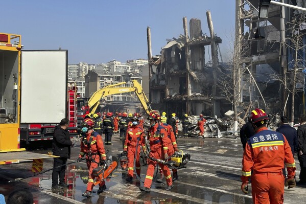 Firefighters work the scene of an explosion in Sanhe city in northern China’s Hebei province on Wednesday, March 13, 2024. Rescuers were responding to a suspected gas leak explosion Wednesday in a building in northern China, authorities said. (AP Photo/Ng Han Guan)