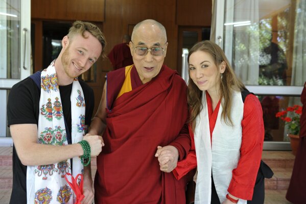 This image released by the Office of His Holiness the Dalai Lama shows the Dalai Lama, center, with Abe Kunin, left, and Junelle Kunin. The Tibetan spiritual leader will release his first album, "Inner World" featuring teachings and mantras set to music. The album will be released on July 6. (Ven. Tenzin Jamphel/Office of His Holiness the Dalai Lama via AP)
