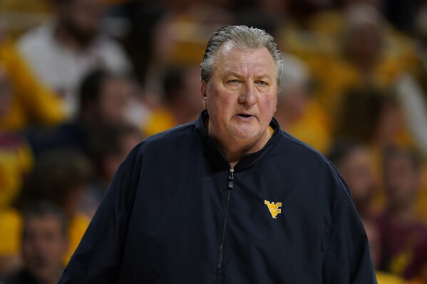 FILE - West Virginia head coach Bob Huggins watches from the bench during the first half of an NCAA college basketball game against Iowa State, Monday, Feb. 27, 2023, in Ames, Iowa. Huggins has been arrested on suspicion of drunken driving, Friday, June 16, a month after the university suspended him for three games for using an anti-gay slur while also denigrating Catholics during a radio interview. (AP Photo/Charlie Neibergall, File)